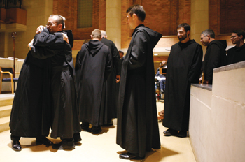 Brother Luke is greeted by Father Michael Santa. Each member of the community offered an embrace of acceptance and welcome to the new novices..
