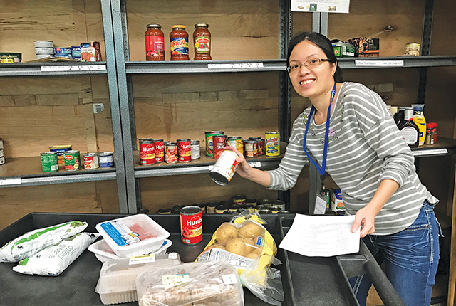 Vision 2026 Feister 5 Religious communities embrace diverse members Sister Phuong Dong, R.S.M. helps out at a food pantry.