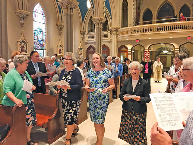 Vision 2026 Schuck Scheiber 2 Need-to-knows about becoming a nun Sister Colleen Gibson, S.S.J. (center) is surrounded by her community during her final vows ceremony.
