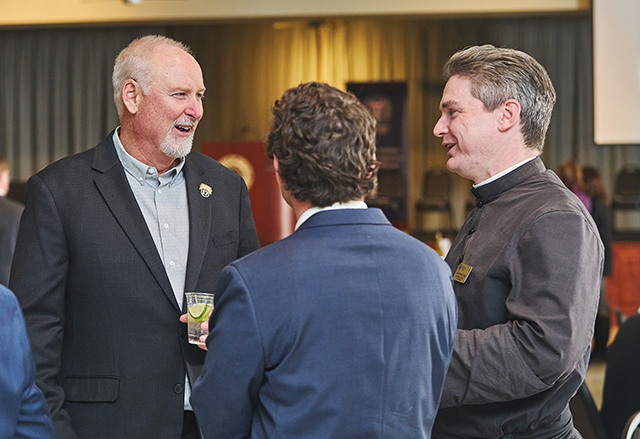 Vision 2026 Pierce 5 About-face to the priesthood Brother Nathaniel Pierce, S.J.C. talks with others at an event focused on a key document in Catholic social teaching.